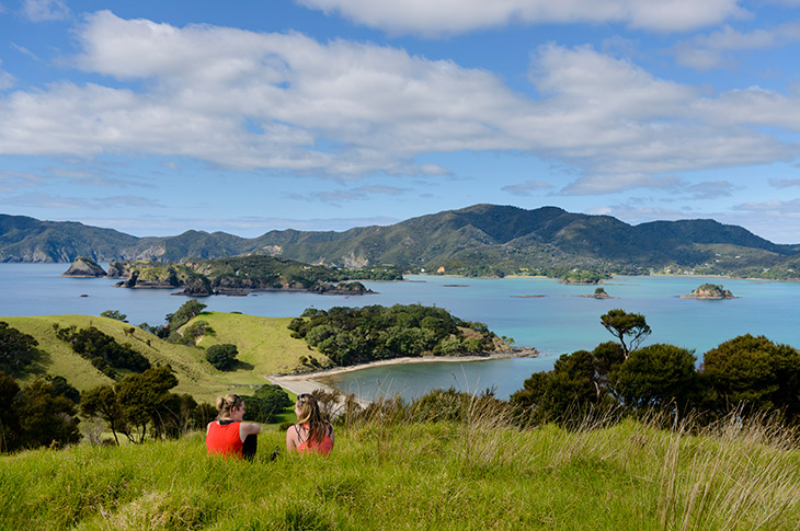 Couples enjoying Bay of Islands views from Urupukapuka Island